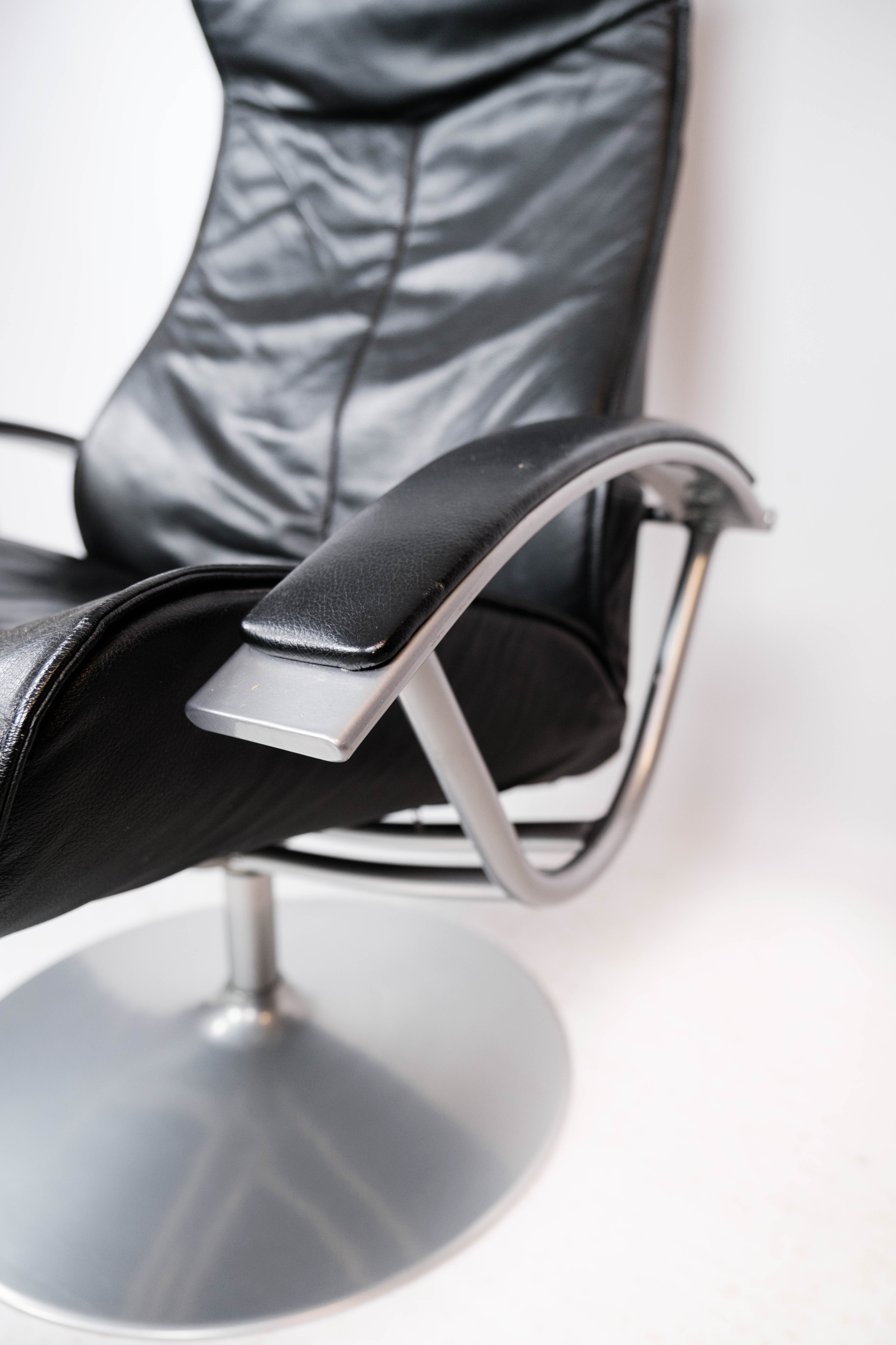 Easy chair with stool upholstered with black leather of Danish design, 1970s