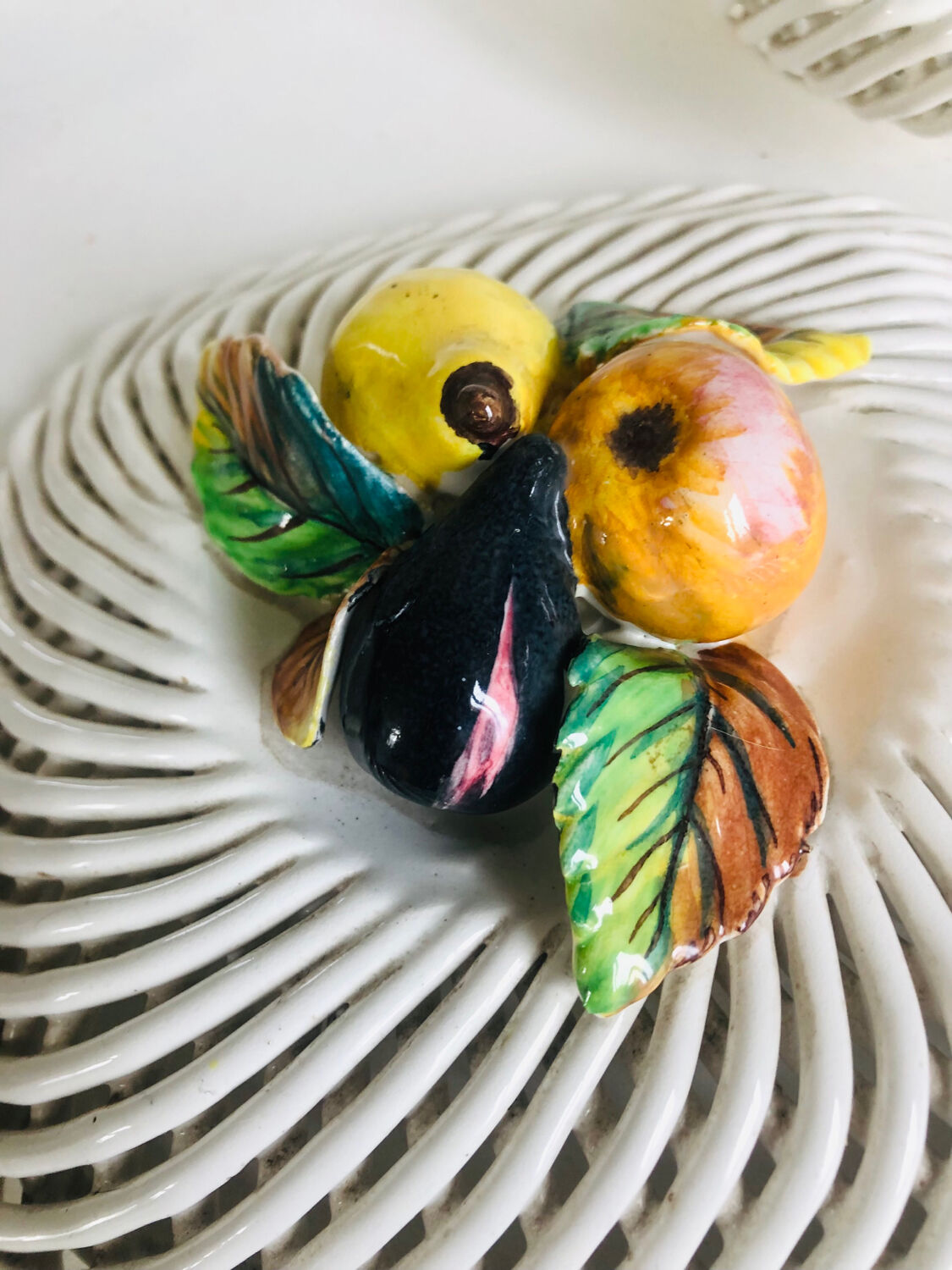 Covered basket in woven ceramic and fruit slip.