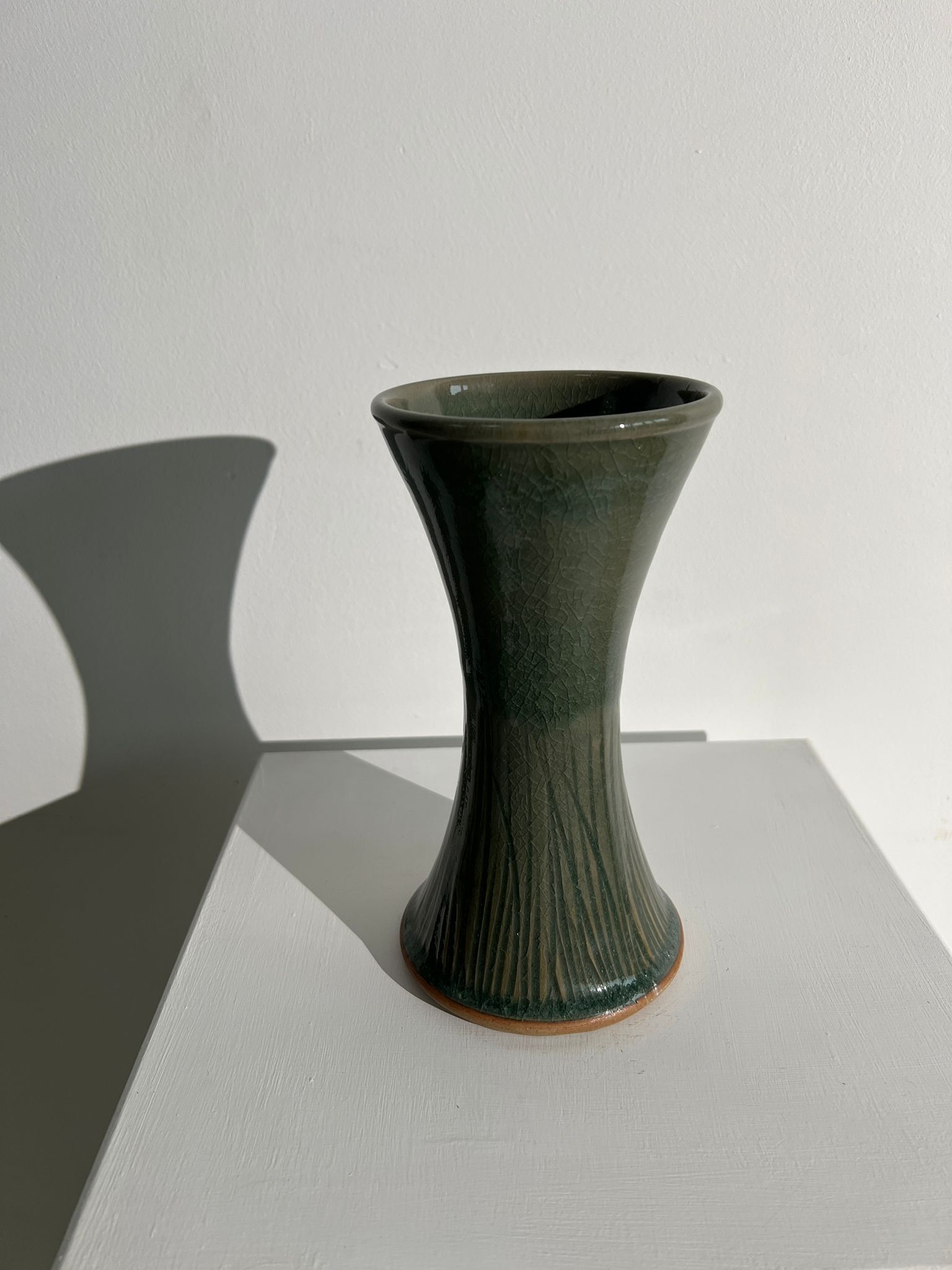 Dark green handcrafted vase with glazed ceramic grass blades