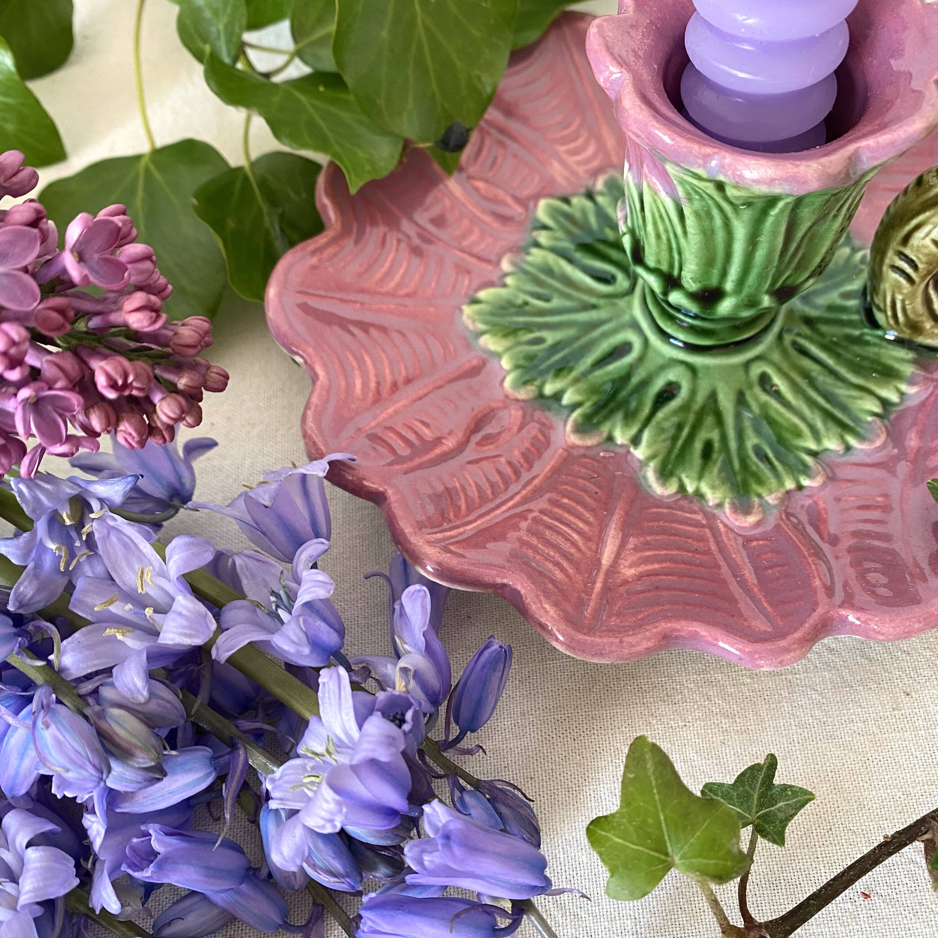 Antique slip candlestick depicting a flower