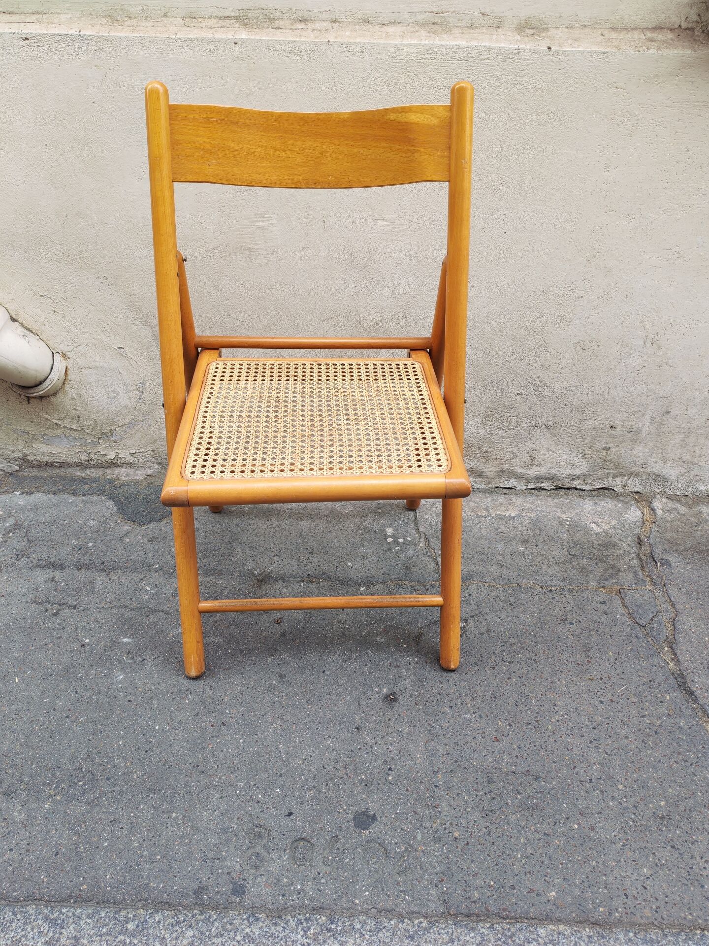 Wooden folding chair with caning from the 1980s.