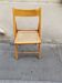 Wooden folding chair with caning from the 1980s.