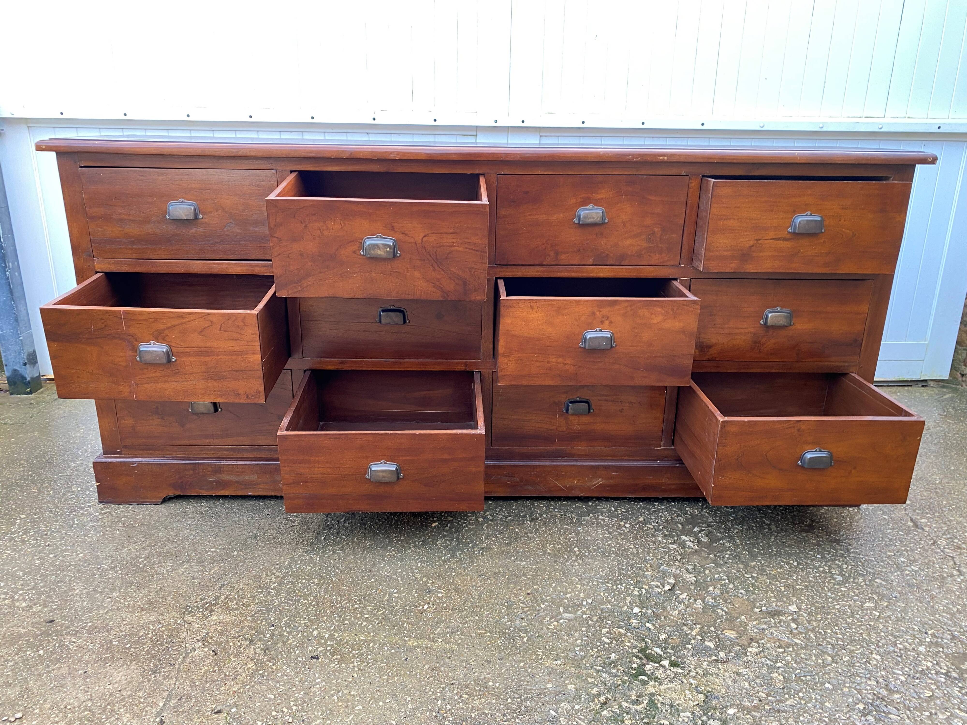 Old and authentic trade storage unit counter with 12 large drawers in cherry wood 1950
