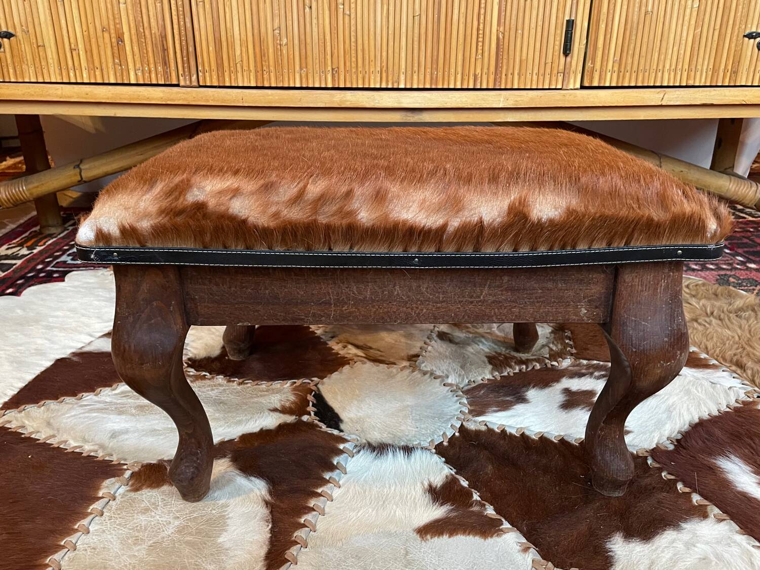 Vintage wooden and goatskin pouf