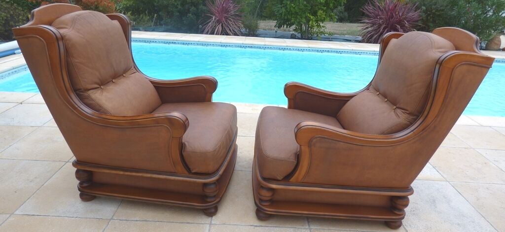 Pair of aged leather armchairs with seat and firm backrest with cherry wood frame