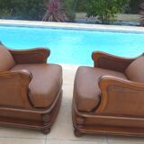 Pair of aged leather armchairs with seat and firm backrest with cherry wood frame