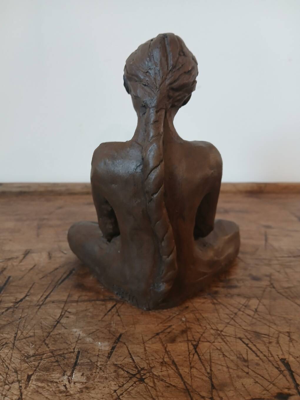 Terracotta statue of a woman with child, signed