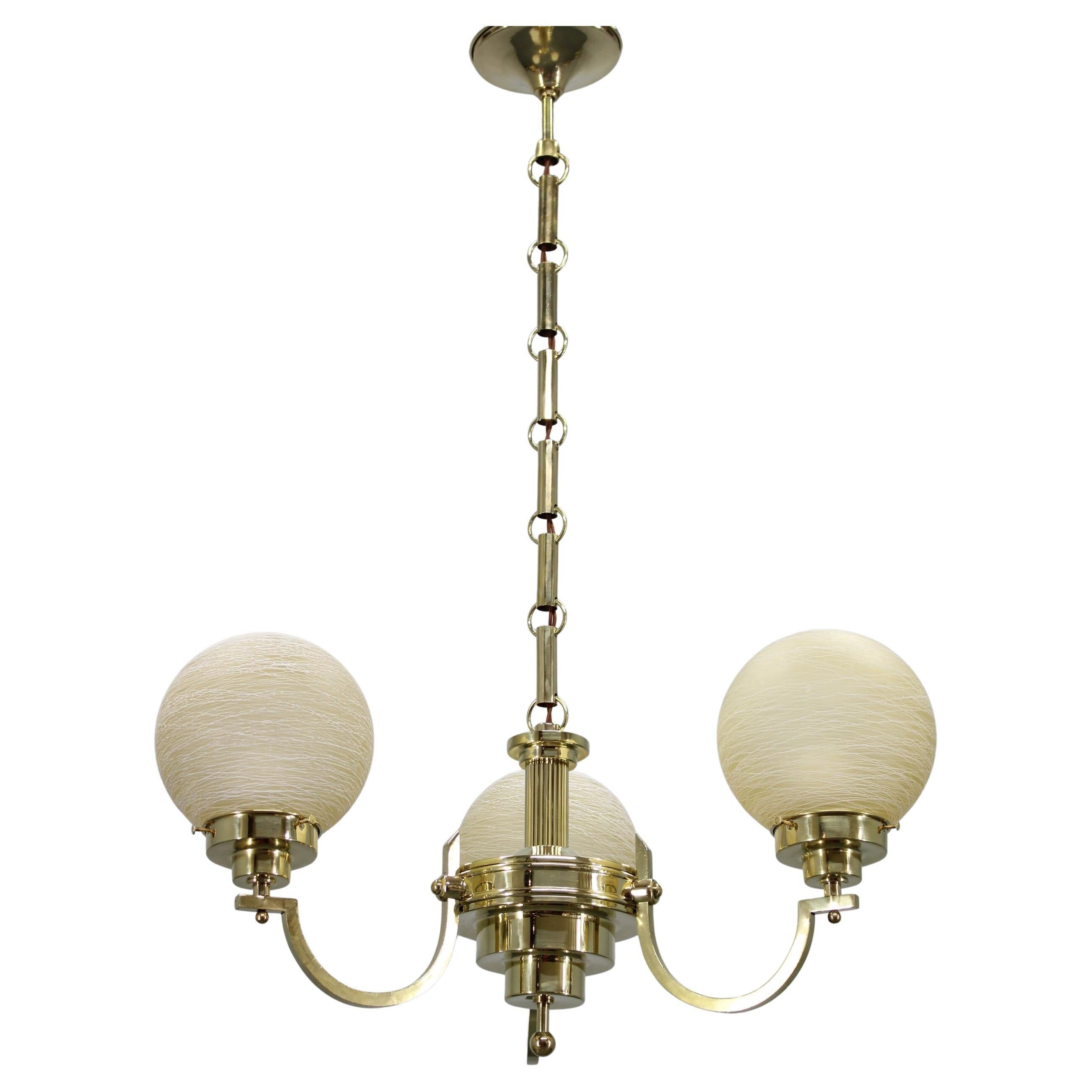1930s Art Deco brass chandelier with textured glass globes, Czechoslovakia