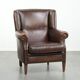 Subtle sheepskin wingback armchair with a deep cognac colour