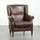 Subtle sheepskin wingback armchair with a deep cognac colour