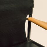 Maërl armchair, Galathée model, black leather, solid wood armrests of your choice