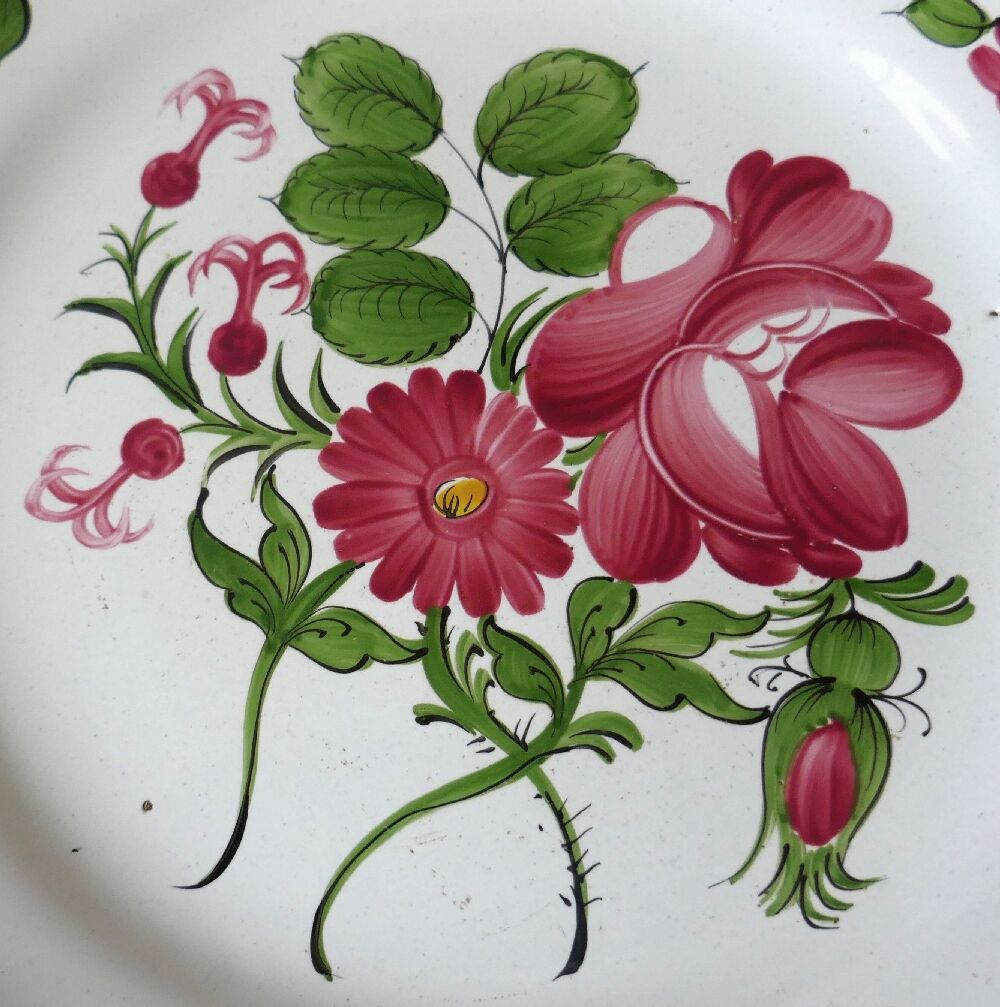 Antique polychrome earthenware plate from eastern France with flower decoration, 19th century