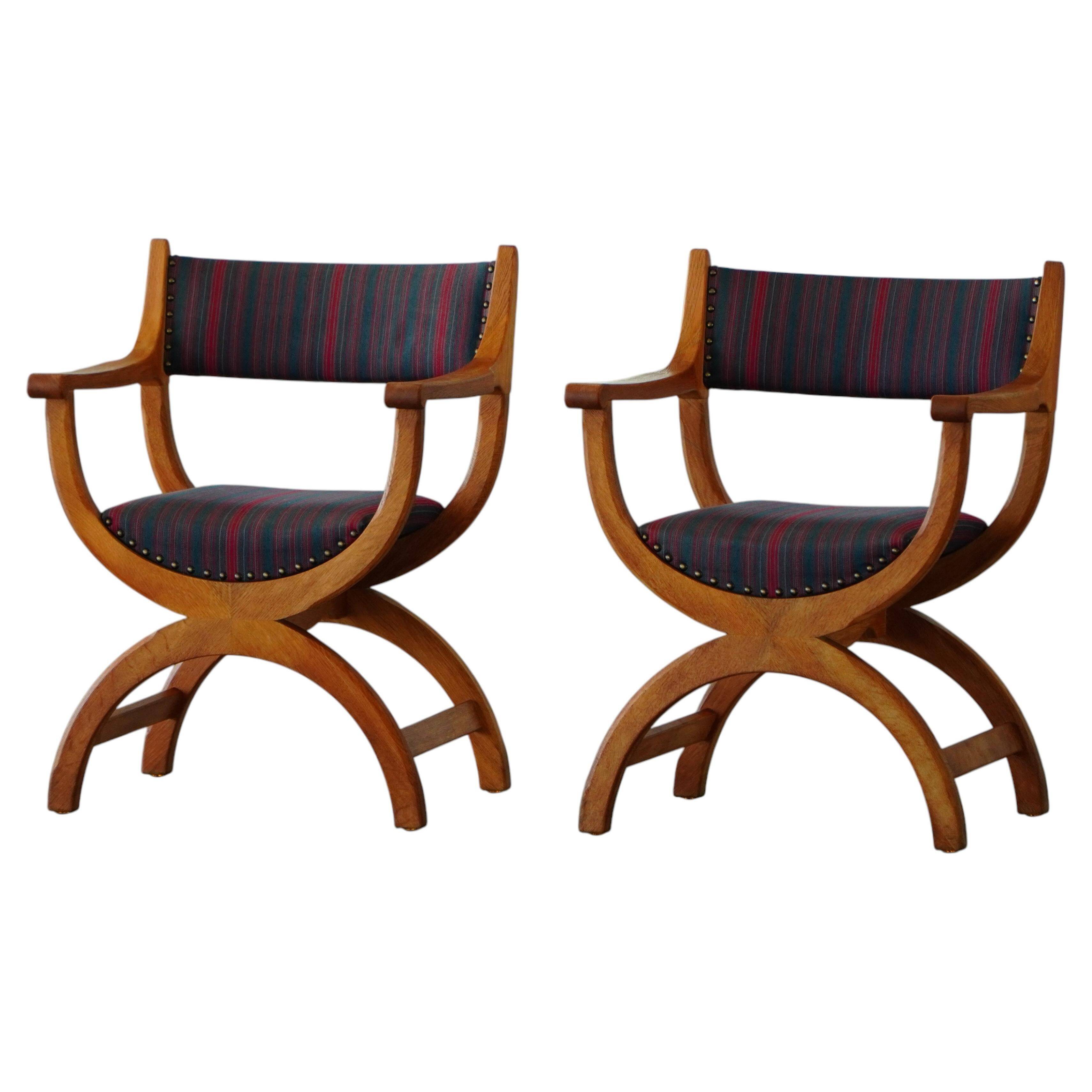Henning Kjærnulf, pair of oak armchairs, model "Kurul", Danish modern style, 1960s.