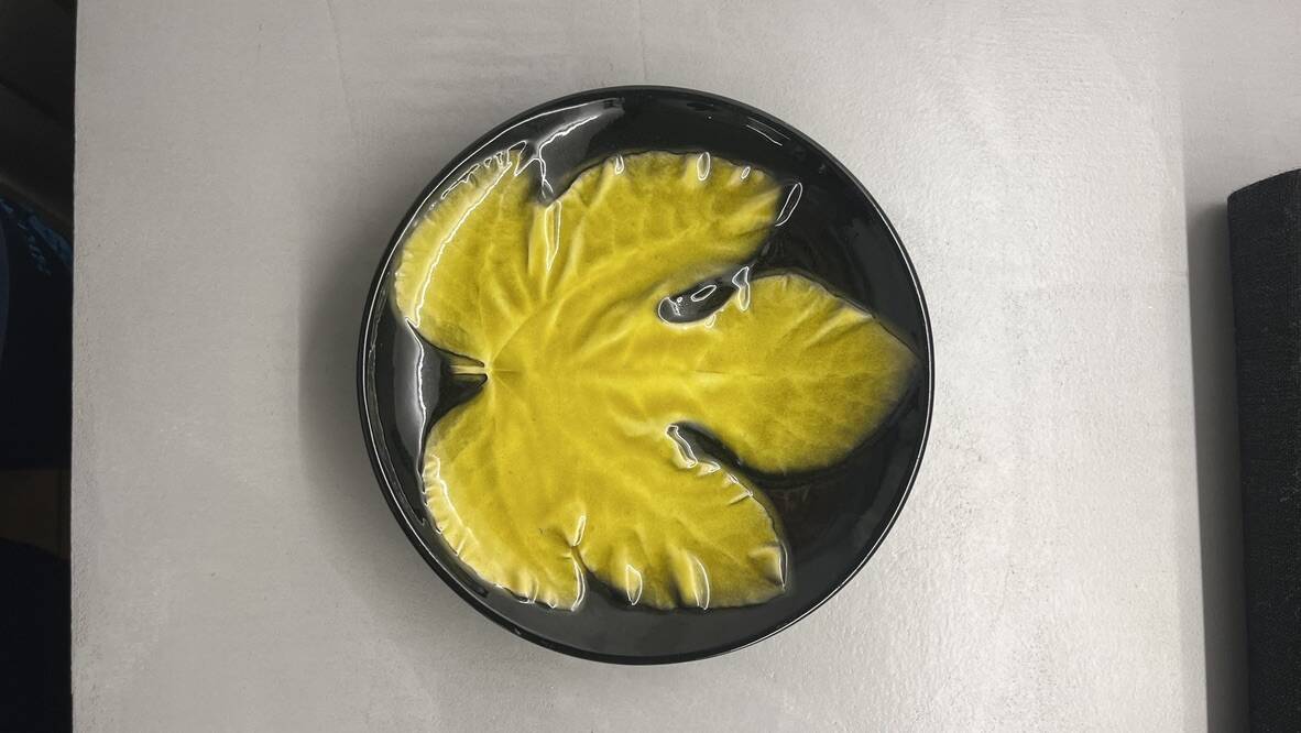 Wall plate by Pol Chambost with leaf pattern.