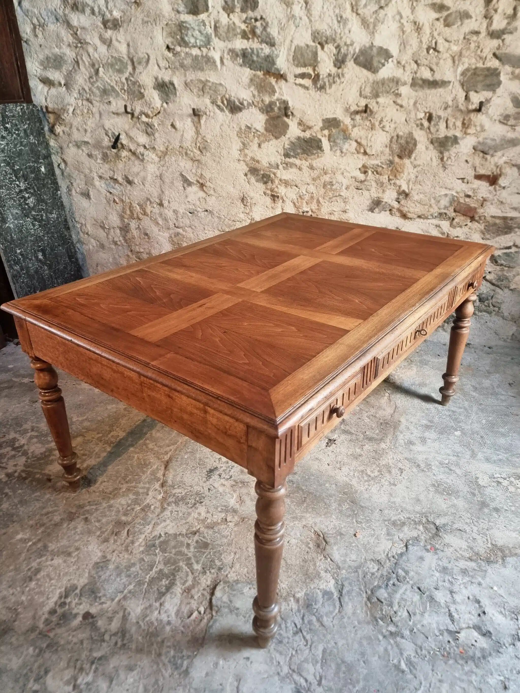 Antique French walnut table with six drawers, parquet top, early 20th century.