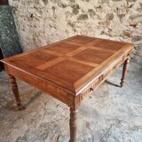 Antique French walnut table with six drawers, parquet top, early 20th century.