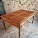 Antique French walnut table with six drawers, parquet top, early 20th century.