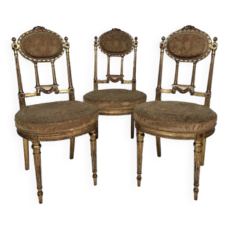 Series of three Louis XVI style chairs in gilded wood, circa 1900