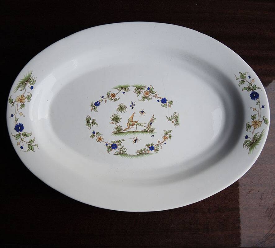 Old large oval serving dish in Moustiers earthenware.
