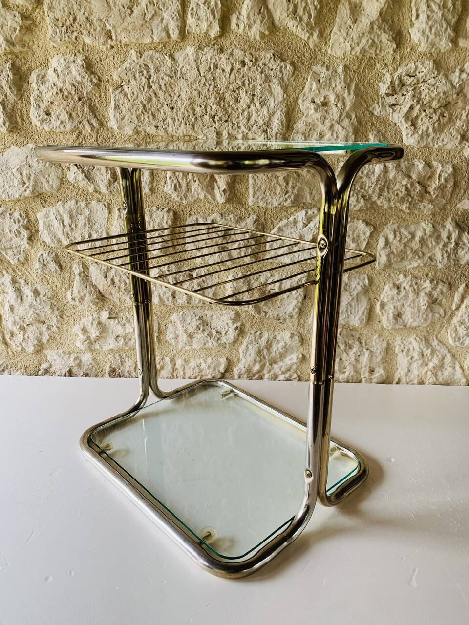 Glass and brass side table with magazine rack, circa 1970's