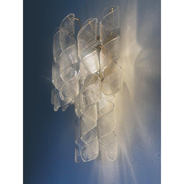 A pair of transparent “ricci” murano glass wall sconces