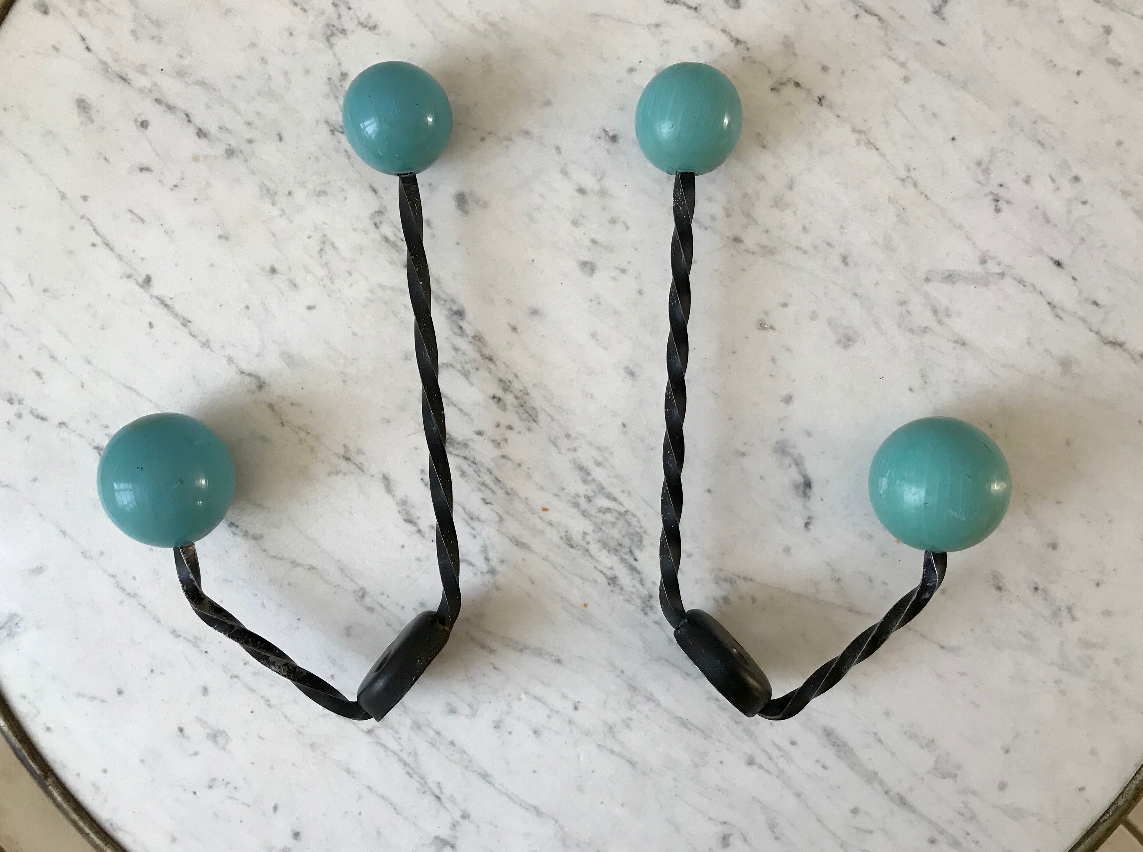 Duo of hooks balls in blue wood and black iron 60s