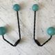 Duo of hooks balls in blue wood and black iron 60s