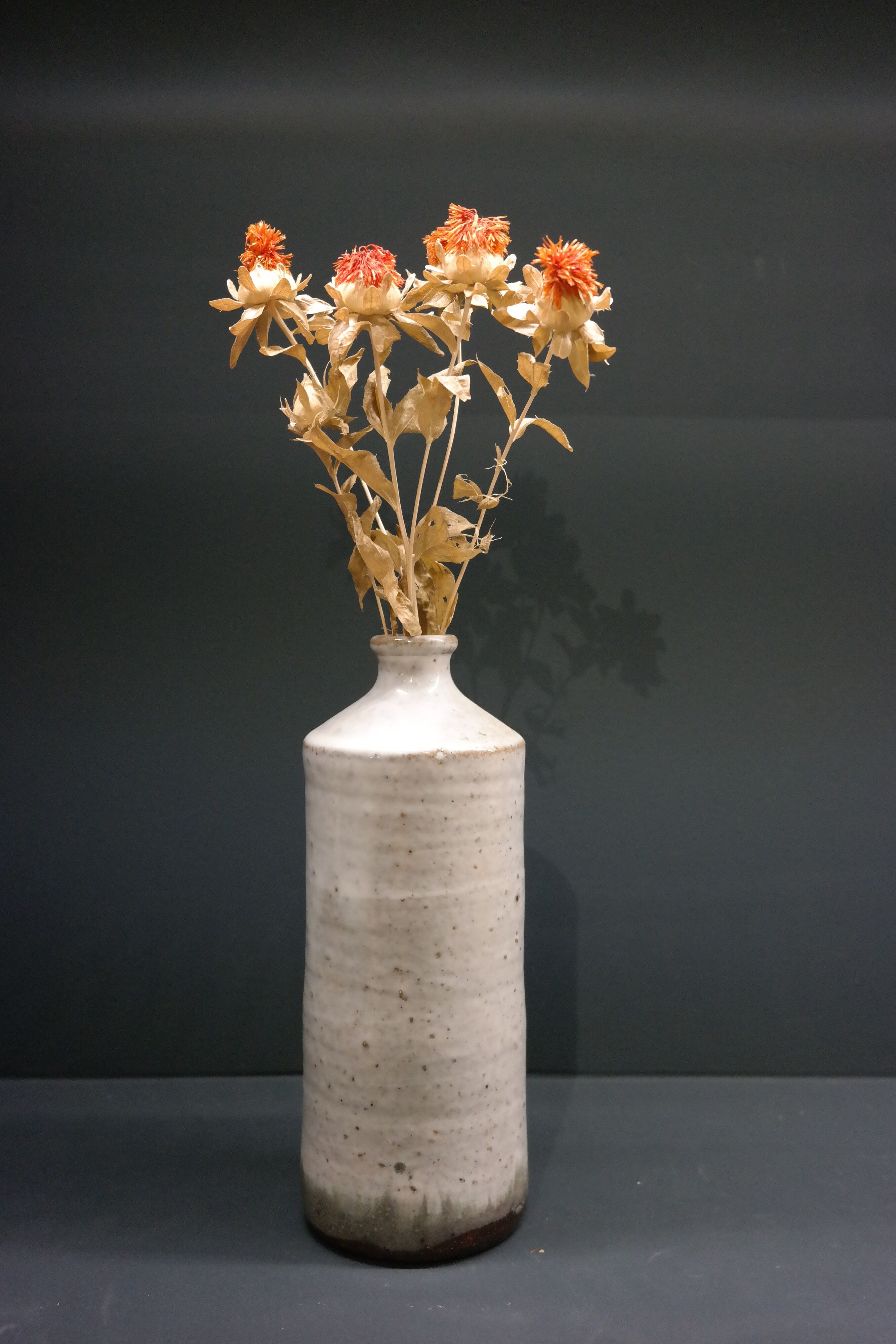 White enamelled sandstone bottle-shaped vase