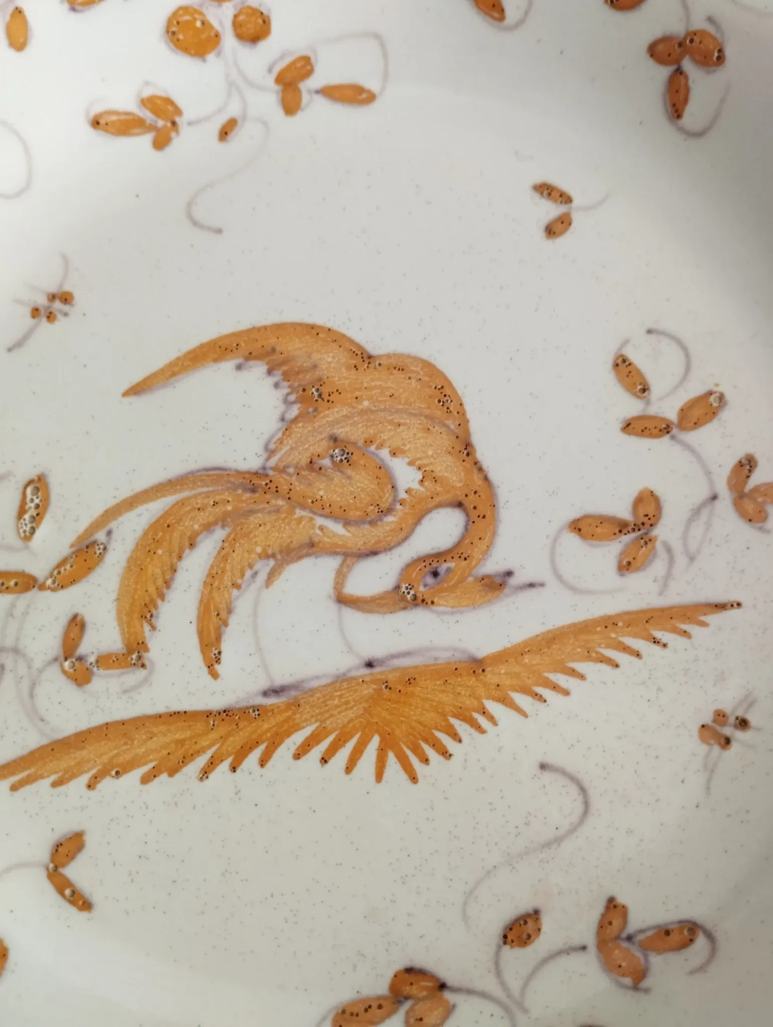 Pair of antique plates with a bird of paradise design in the style of Moustiers.