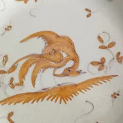 Pair of antique plates with a bird of paradise design in the style of Moustiers.
