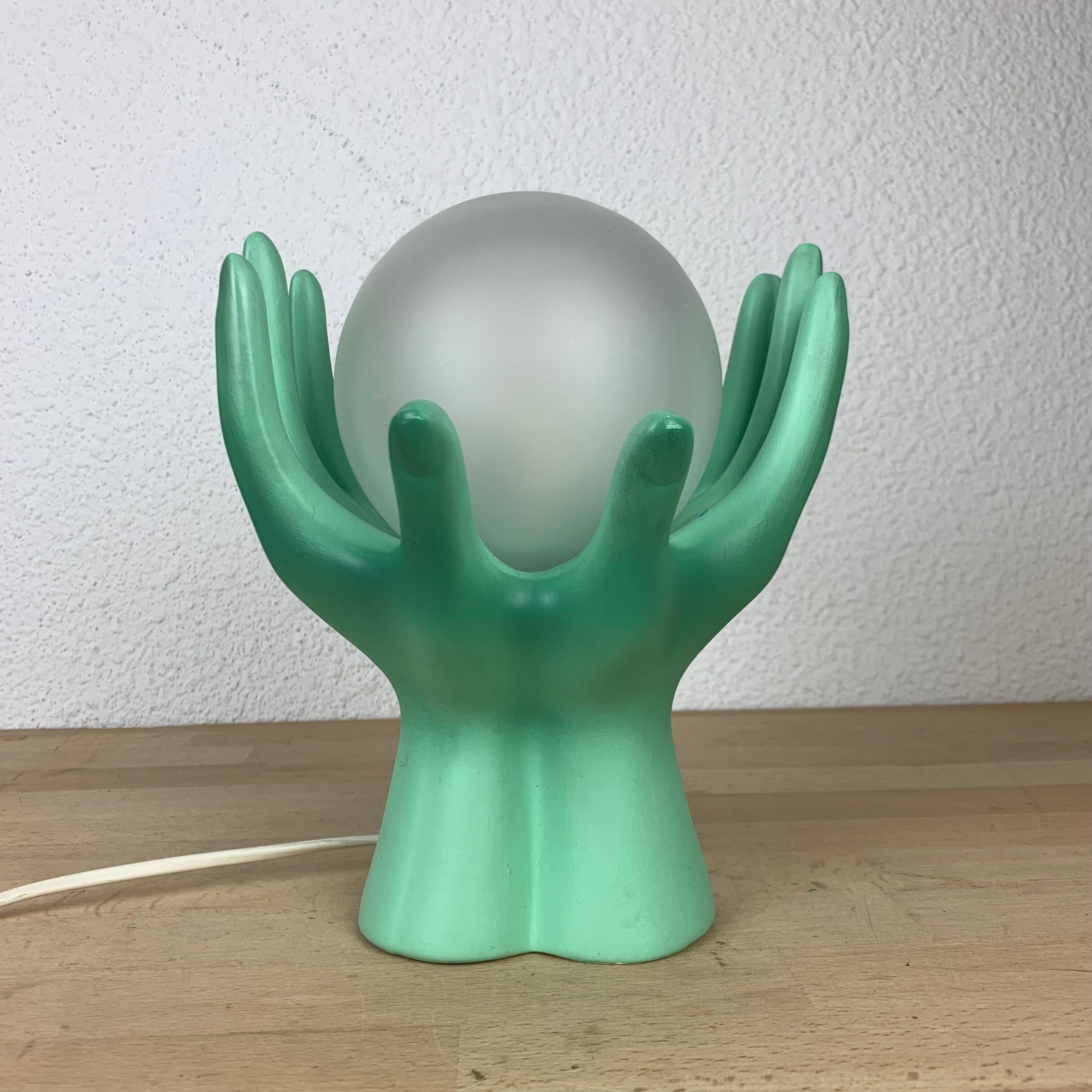 Green ceramic hand lamp and glass globe