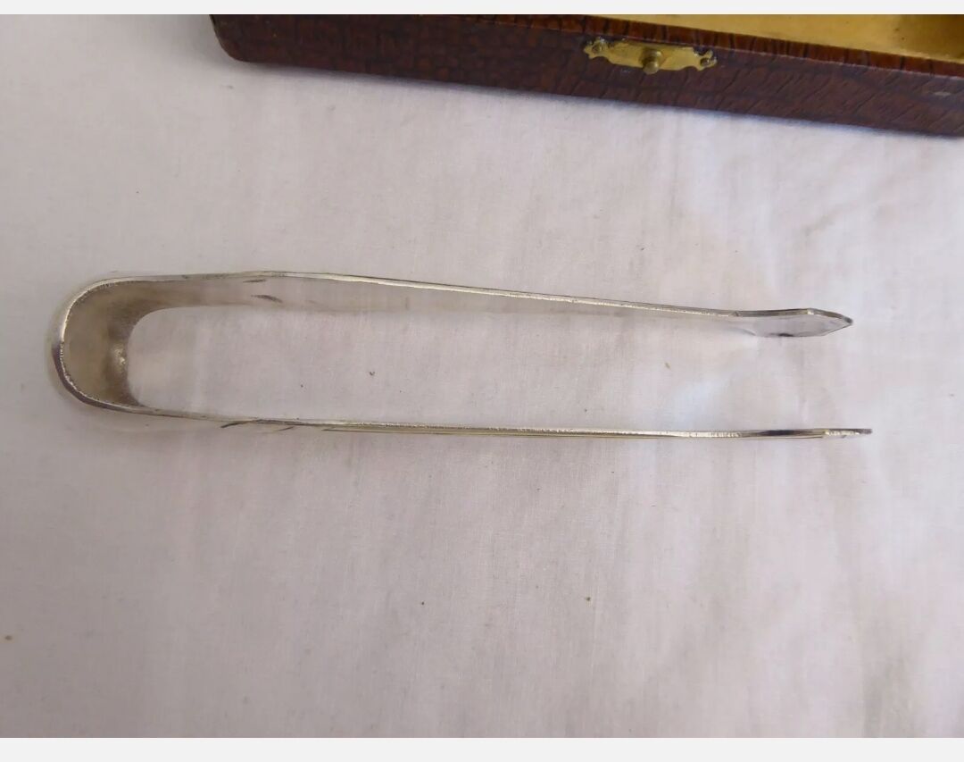Silver metal sugar clamp in its case
