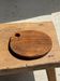 Average circular teak monoxyle chopping board with handle 26 x 18.