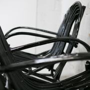 Pair of black lacquered rattan armchairs. France, cira 1960.