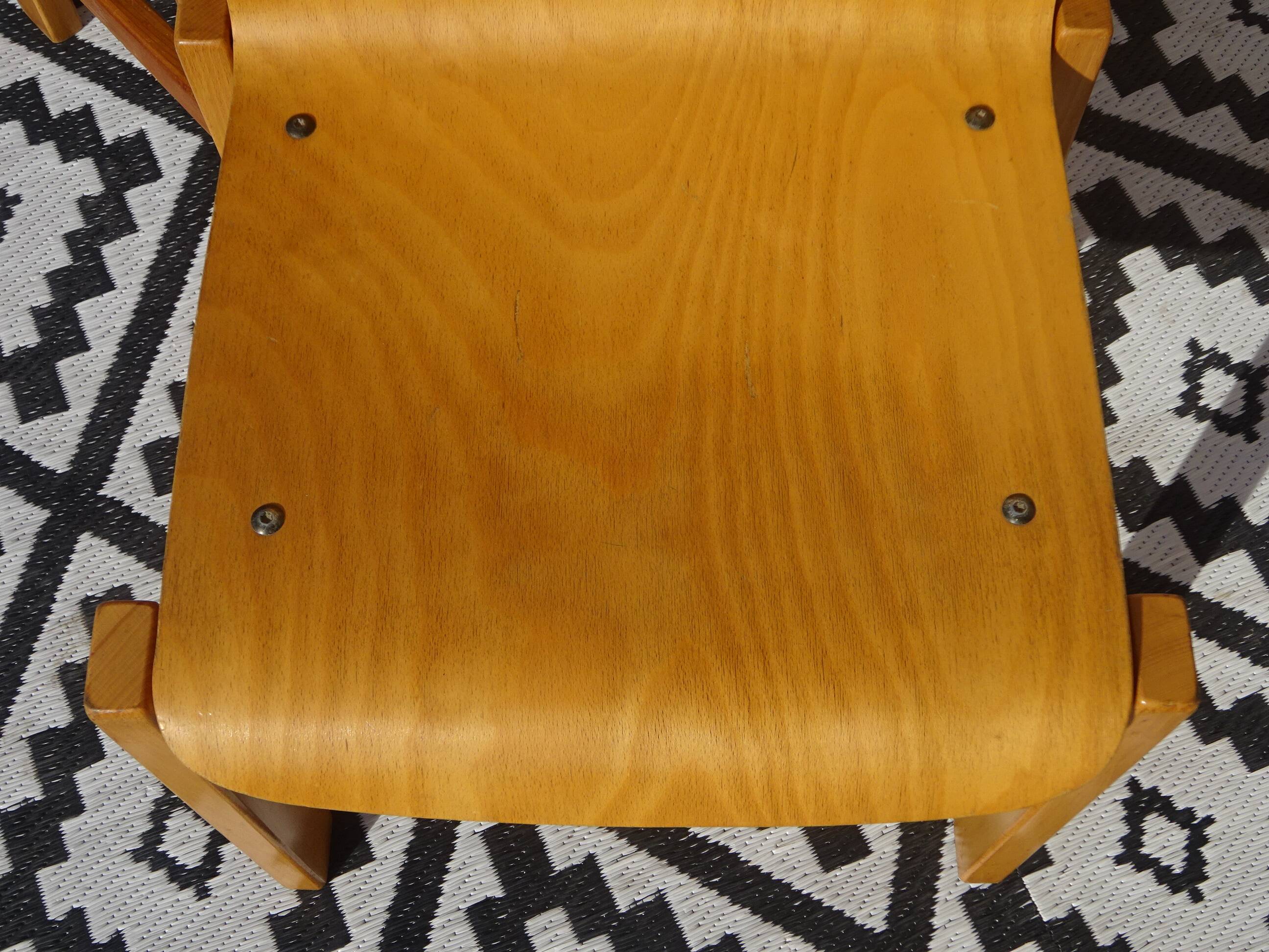 Pair of light wood chairs with post-formed seat and backrest.
