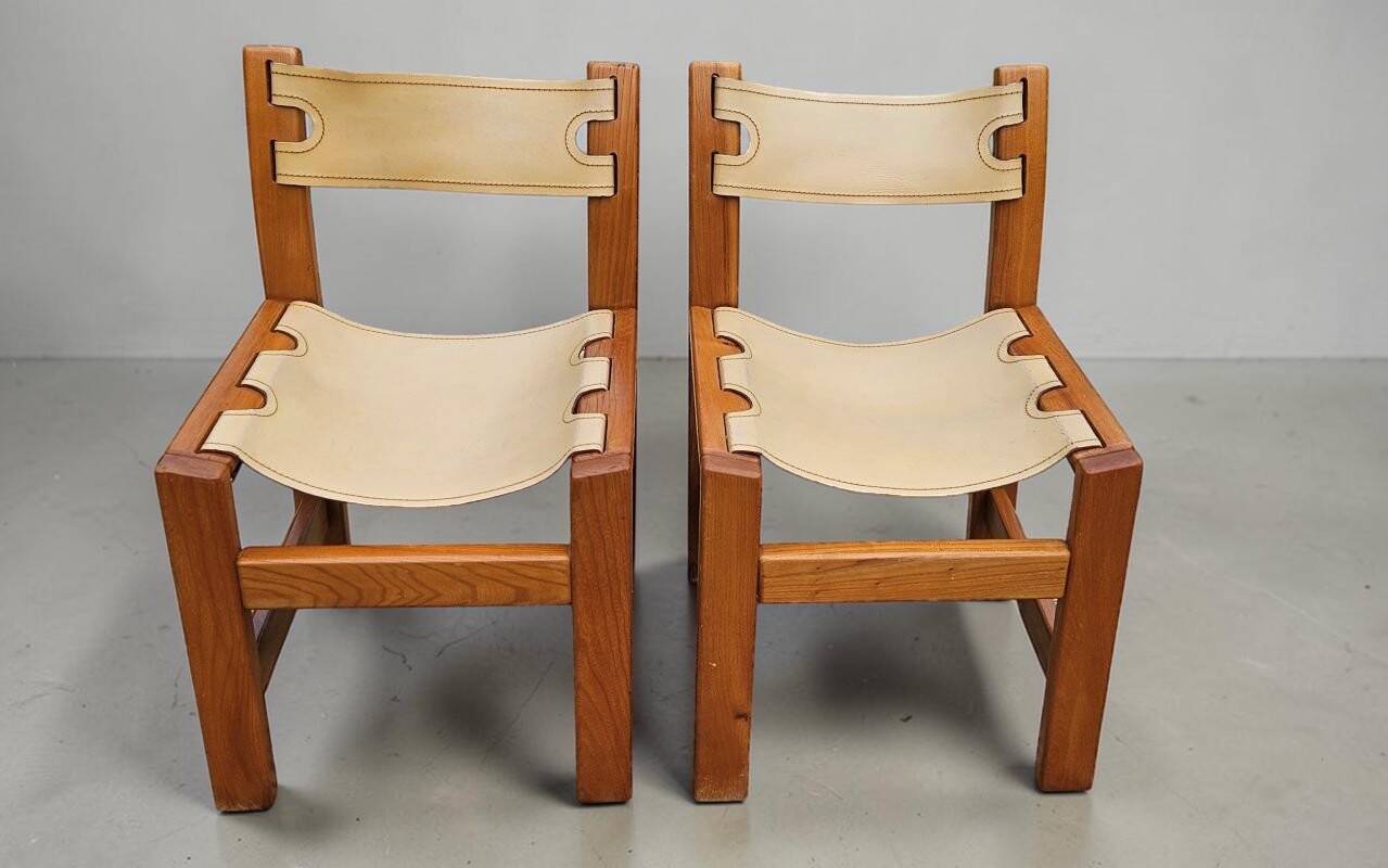 Pair of elm and leather chairs by Maison Regain