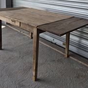 Old farmhouse table with its 2 extensions and raised legs.