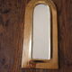 Rounded brass mirror