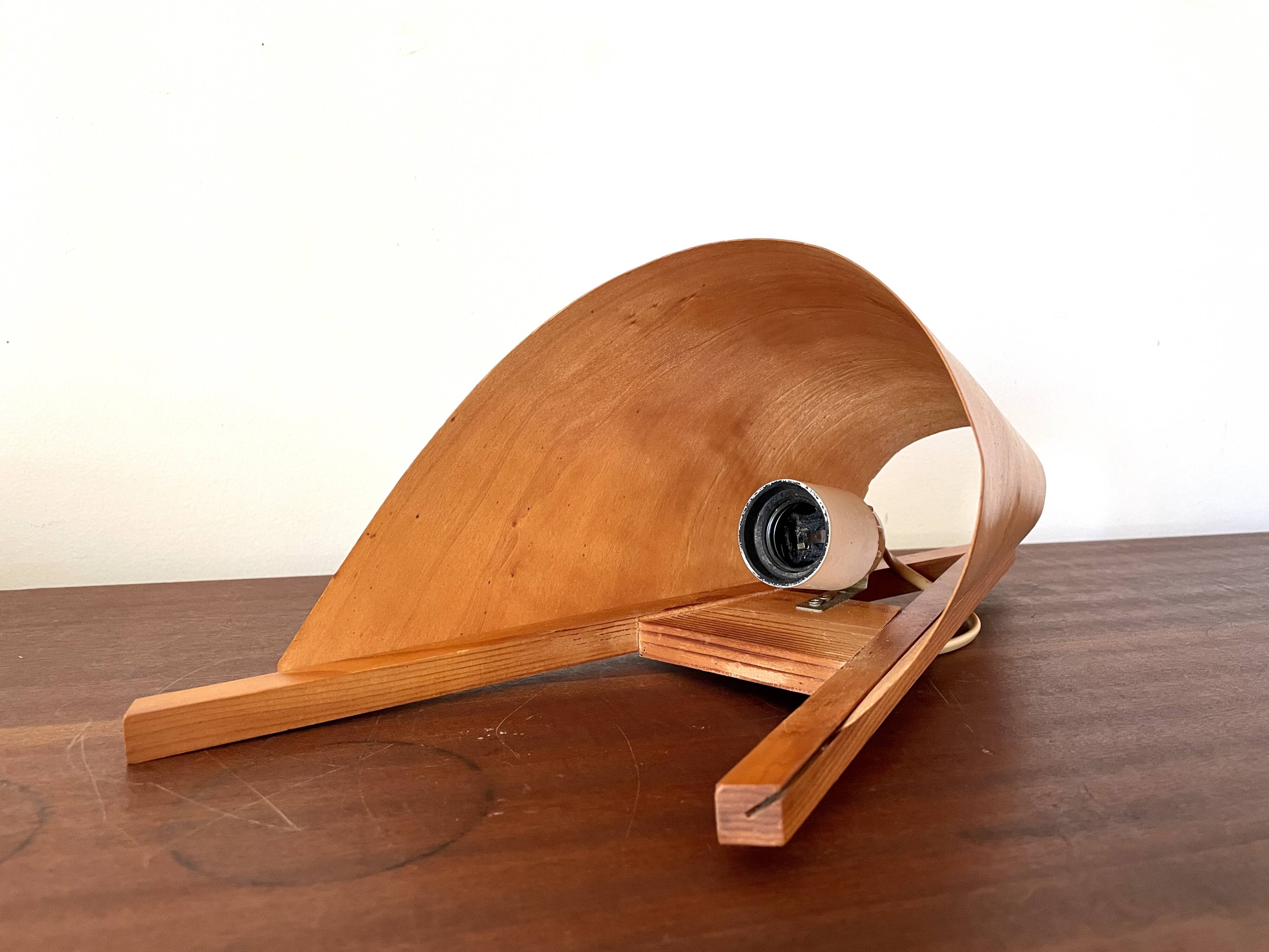 Large wood veneer wall light on the right, 1980.