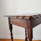 Antique solid oak side table with turned wooden legs.