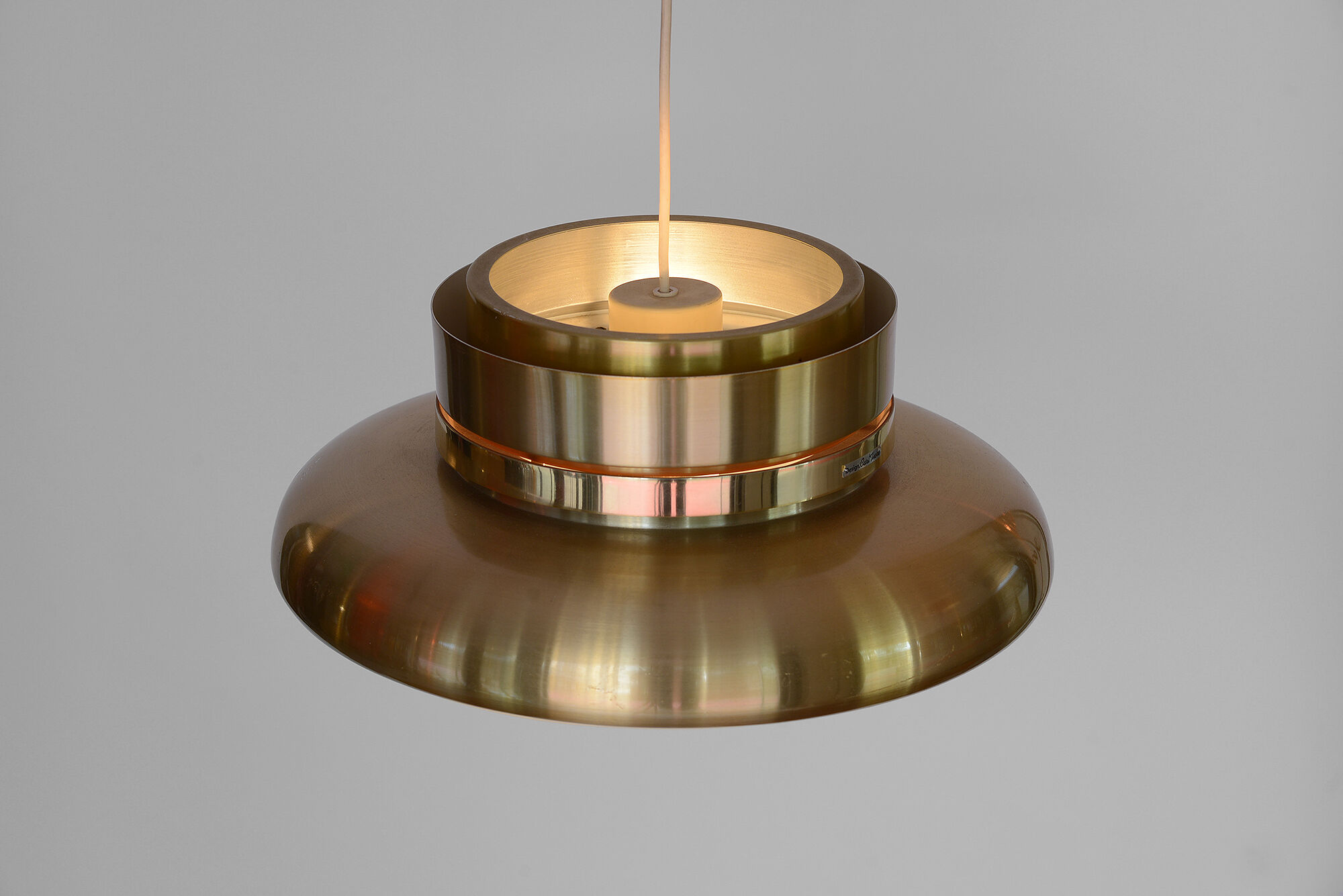 Gold coloured aluminium hanging light by Carl-Thore for Granhaga.