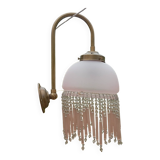 Brass swan neck wall lamp with pink glass globe and Charleston tassels
