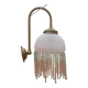 Brass swan neck wall lamp with pink glass globe and Charleston tassels