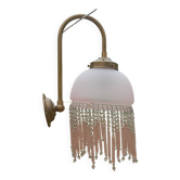 Brass swan neck wall lamp with pink glass globe and Charleston tassels