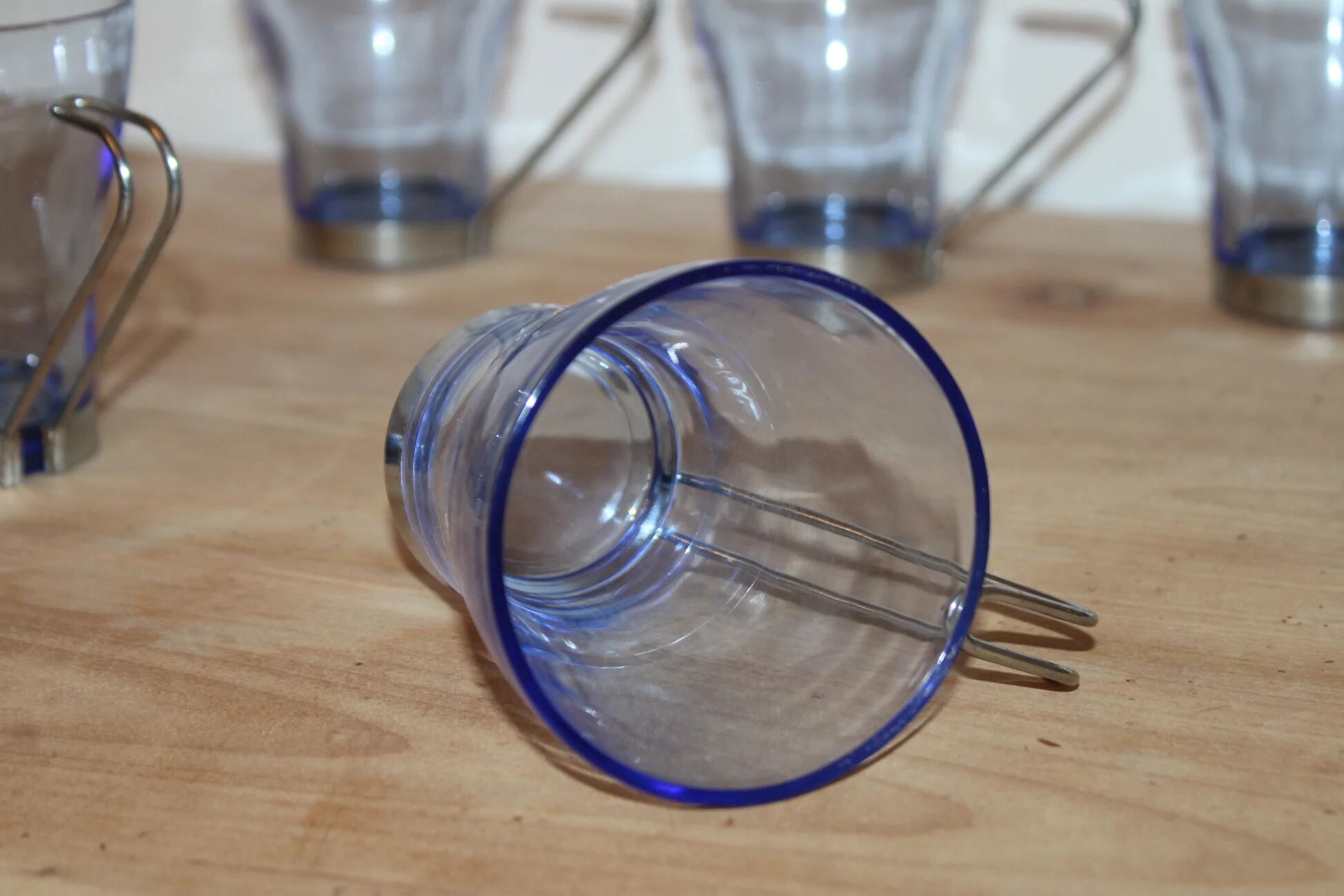 Set of 5 vintage blue-tinted glass cups with metal holders.