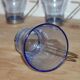 Set of 5 vintage blue-tinted glass cups with metal holders.