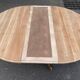 Round dining table with a central pedestal, extendable, stripped in solid walnut with 2 extensions.