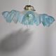 Suspension lampshade with scalloped edges in blue and its interior decoration.
