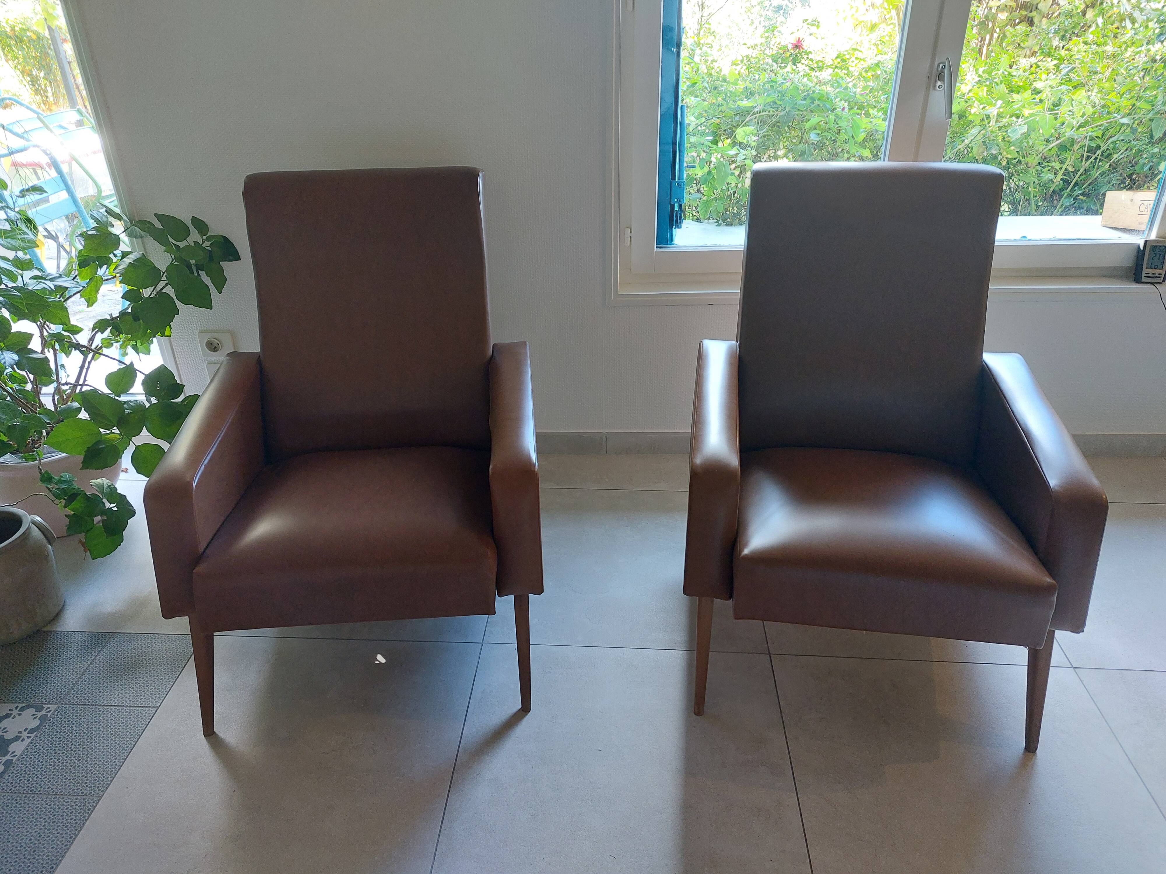 a pair of comfortable vintage armchairs with splayed legs