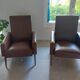 a pair of comfortable vintage armchairs with splayed legs